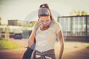 Young sport woman talking phone.