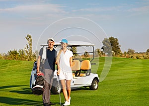 Young sportive couple playing golf on a golf course