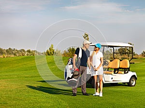 Young sportive couple playing golf on a golf course