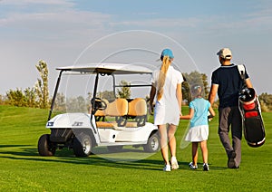 Young sportive family playing golf