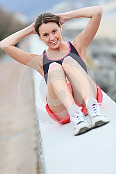 Young sportive girl doing sports outdoors