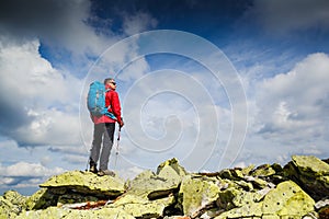 Young sportive hiker trekking in the mountains. Sport and active life