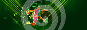 Young sportive man, basketball player in motion, jumping with ball on green background with polygonal and fluid neon