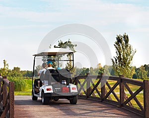 Young sportive people in the golfcar