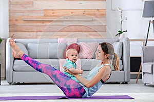 Young sportive woman doing exercise with her son at home