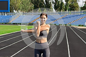 Young sports fitness woman warming up, Girl have stretching training in running stadium. People sport and fitness concept