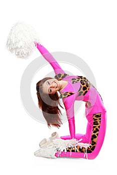 Young sports flexible cheerleader girl in the pink leo suit bends backwards.