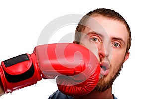 A young sports man-boxer poses to the camera. Man got a punch to the face by red boxing glove