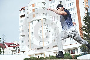 Young sports man doing parkour in the city.