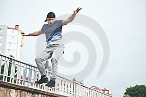 Young sports man doing parkour in the city.