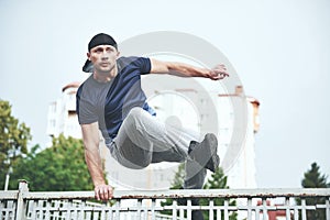 Young sports man doing parkour in the city.