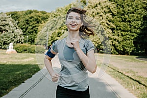 Young sports woman stretching legs on the stairs in the modern city. Healthy lifestyle in the big city. Sports woman relaxing list