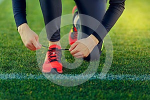 Young sportsman dresses his shoes