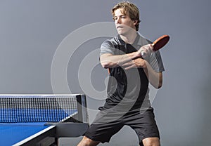 Young sportsman playing table tennis