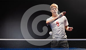 Young sportsman playing table tennis