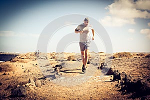 Young sportsman running at beach coast.
