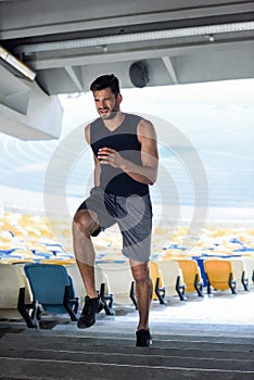 Young sportsman running on stairs at