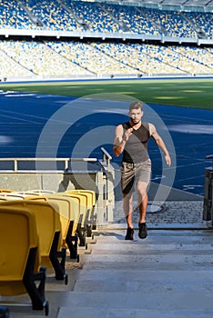 Young sportsman running on stairs at