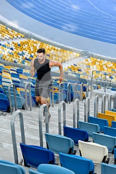 Young sportsman running on stairs at