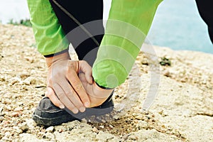 Young sportsman stretching his legs