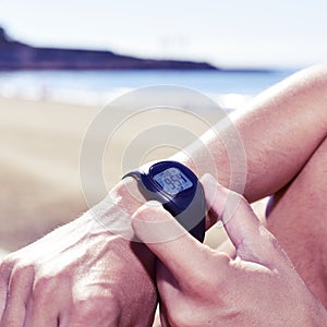 Young sportsman syncing his smartwatch