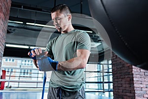 Young sportsman working hard in spacious gym