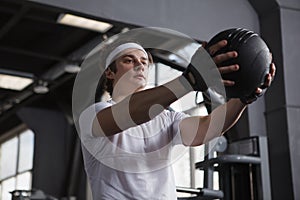 Young sportsman working out at the gym