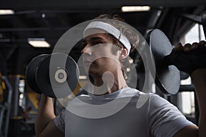 Young sportsman working out at the gym