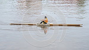 Young sportsmen in a boat, rowing on the river Rioni, Poti, Georgia