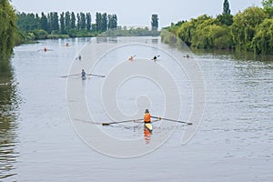 Young sportsmen in a boat, rowing on the river Rioni, Poti, Georgia