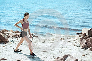 young sportswoman doing exercise with stretching band