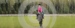 Young sportswoman riding horse in equestrian show jumps competition. Teenage girl ride a horse