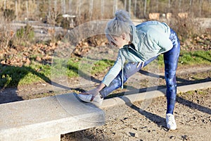 Young sportswoman stretching and preparing to run