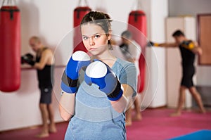 Young sportwoman practicing boxing punches