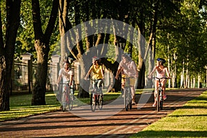 Young sporty active people biking in park.