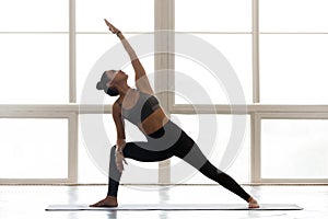 Young sporty attractive woman practicing yoga, doing Reverse War