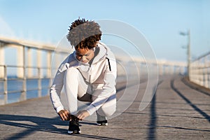 Young Sporty Black Female Tying Shoe Laces, Getting Ready For Jogging Outdoors