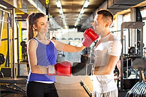 Young sporty couple practicing boxing at the gym.