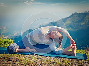 Young sporty fit woman doing Hatha Yoga asana
