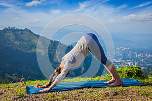 Young sporty fit woman doing yoga oudoors in mountains