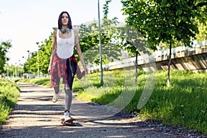 Young sporty girl on skateboards skate on the street