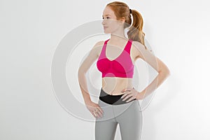 Young sporty girl in sport wear clothes isolated on white background. Happy weight loss woman body concept. Athletic body