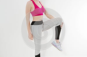 Young sporty girl in sport wear clothes isolated on white background. Happy weight loss woman body concept. Athletic body