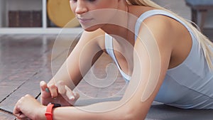 Young and sporty girl in sportswear doing exercises at home. Fit and slender blond woman goes in for sports and fitness