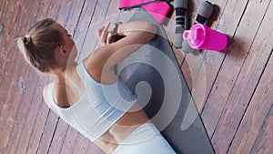 Young and sporty girl in sportswear doing exercises at home. Fit and slender blond woman goes in for sports and fitness