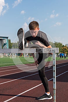 Young sporty man athlete runner in sportswear stretching