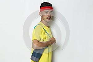 Young sporty man dressed in yellow tshirt on white background