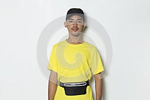 Young sporty man dressed in yellow tshirt on white background