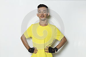 Young sporty man dressed in yellow tshirt on white background