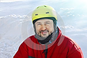 Young sporty man in a helmet in winter